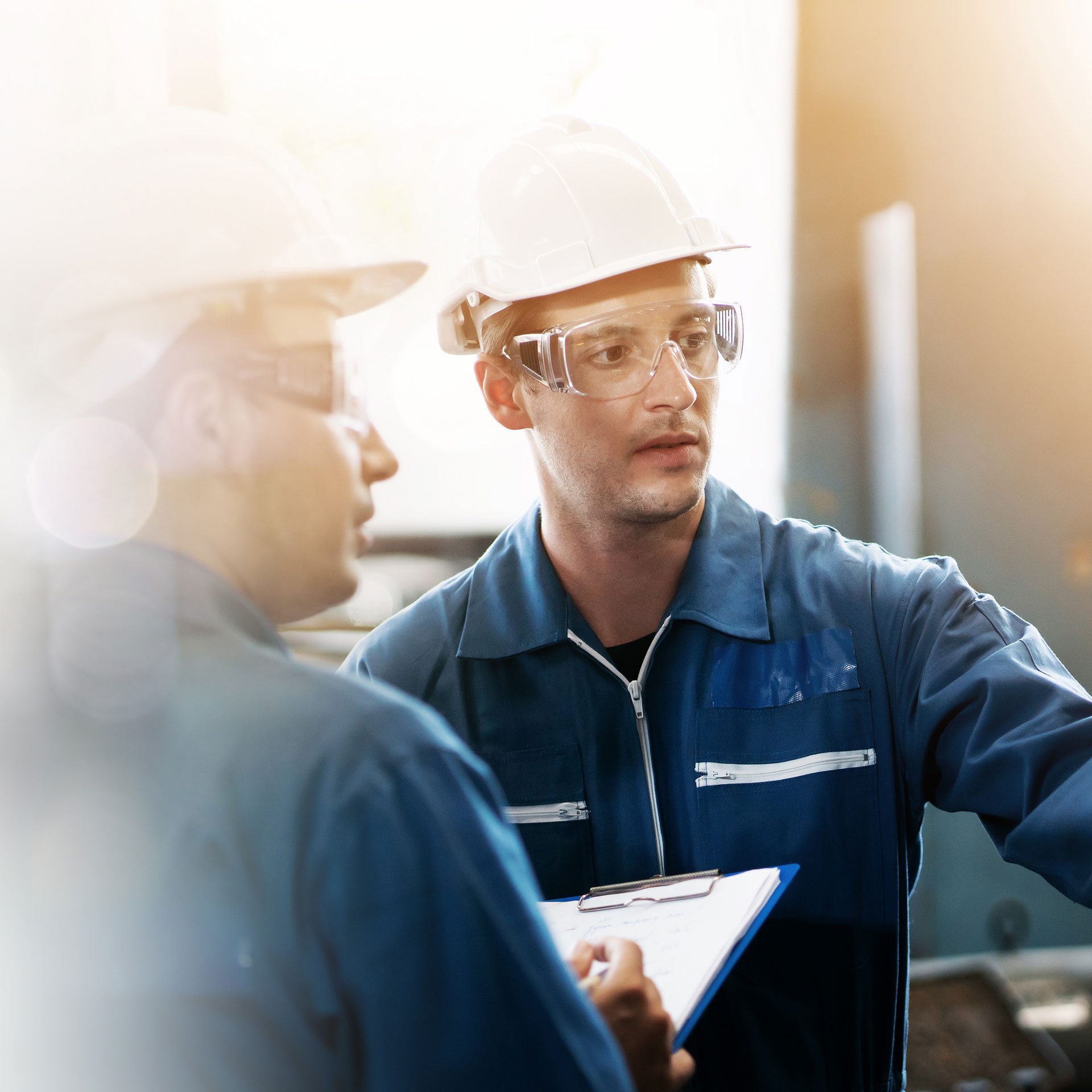 Two workers at a manufacturing plant.